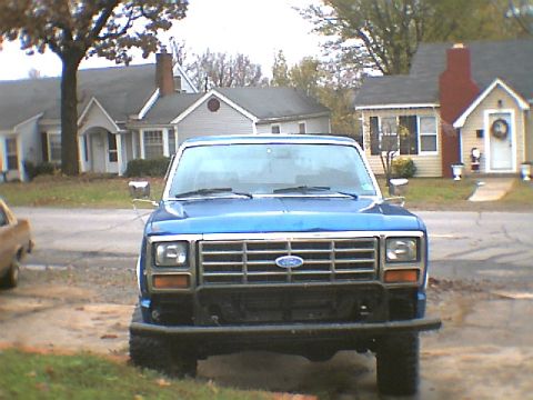 1984 Ford Bronco - Front view of a blue Ford Bronco, likely from the early 1980s.