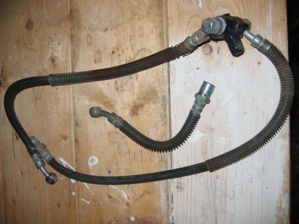 brake hose assembly with metal fittings and ribbed protective sleeves