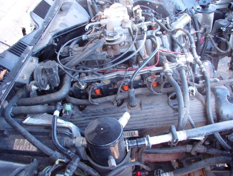 1994 Ford Crown Victoria - The engine compartment of a 1994 Ford Crown Victoria, showing the V8 engine and associated components.