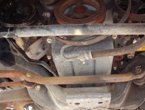 1994 Ford Crown Victoria - Close-up of engine components, showing various hoses, pulleys, and suspension parts.