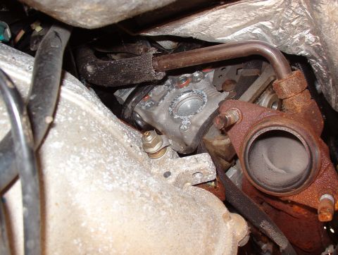 1994 Ford Crown Victoria - Close-up view of engine components, including the exhaust manifold and engine block.