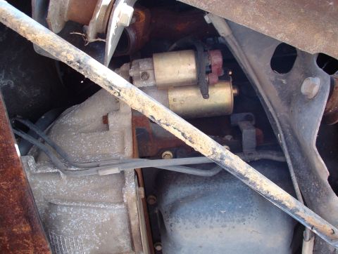 1994 Ford Crown Victoria - Close-up view of a starter motor and transmission housing, likely from an older vehicle.