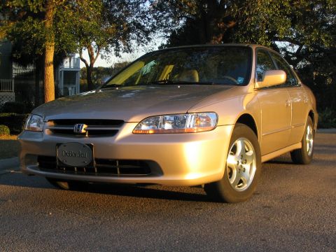 2000 Honda Accord - Gold 2000 Honda Accord sedan parked on a street with trees and a house in the background.