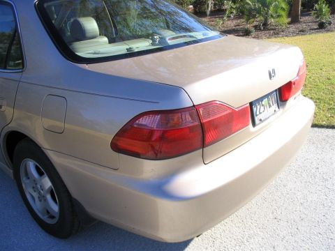 2000 Honda Accord - The rear of a tan sedan is shown, with a clear view of the taillights and license plate.
