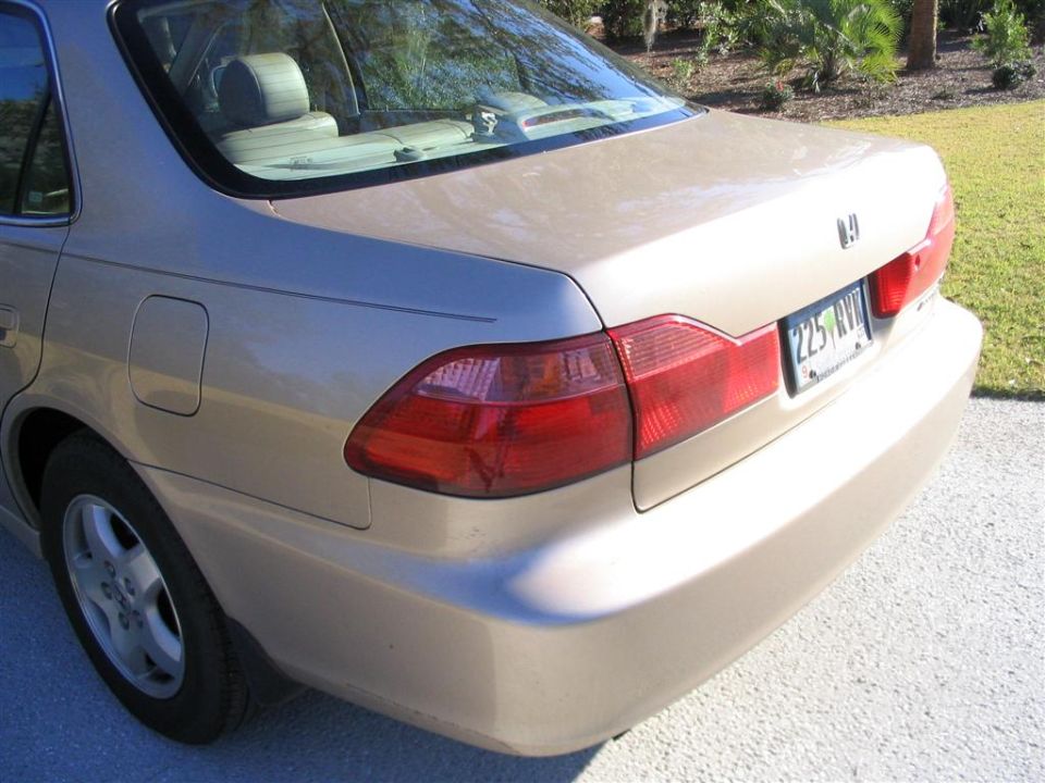Rear 3/4 close-up of gold Honda Accord taillight, fuel door and SC plate 225 RVP