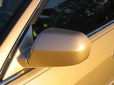 2000 Honda Accord - Side mirror and door panel of a gold 2000 Honda Accord.