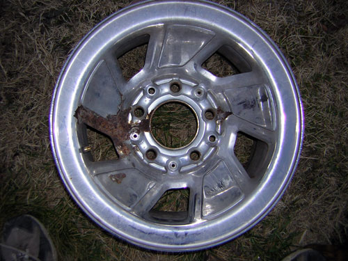 Damaged aluminum wheel with rust on the hub area
