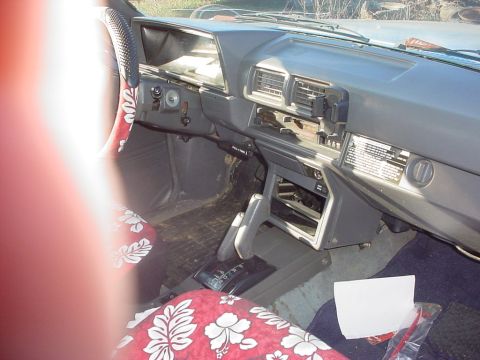 1988 Toyota 4Runner - The interior of a 1988 Toyota 4Runner shows floral seat covers and a worn dashboard.