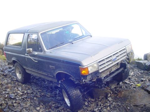 1987 Ford Bronco - A 1987 Ford Bronco navigates a challenging rocky path.