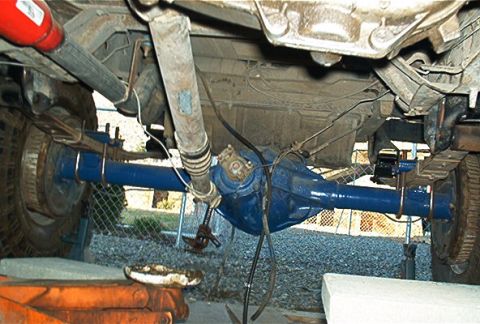 1986 Ford Bronco - Underside view of a vehicle's rear axle assembly, showing suspension components.