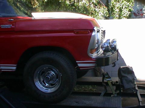 1979 Ford Bronco - A red 1978 Ford Bronco is seen from the front quarter angle, loaded onto a trailer.