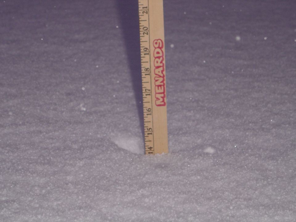 Wooden ruler in snow, measuring approximately 14.5 inches
