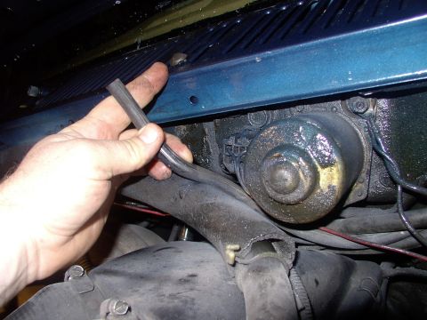 1986 Ford Bronco - Pull off the windshield washer hose off the squirter and let it hang out of the way. Dang ! I forgot to rehook that ! Back in a minute.