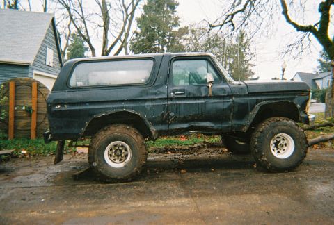 1978 Ford Bronco - Side view of a black 1978 Ford Bronco with lifted suspension and off-road tires.
