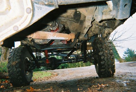 1978 Ford Bronco - This photo shows the undercarriage of a modified 4x4 vehicle, highlighting its suspension and drivetrain components.