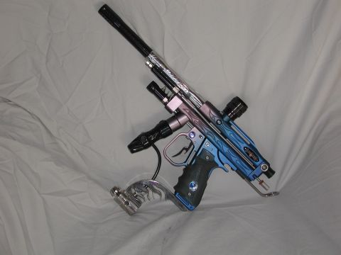 1985 Ford Bronco - A custom-painted paintball gun rests on a white cloth background, displaying intricate flame graphics.