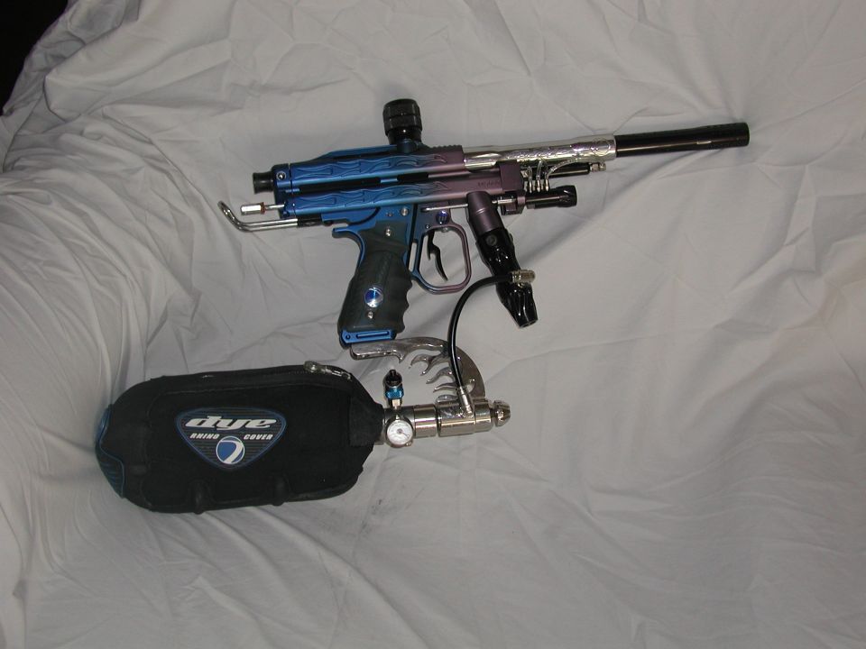 Paintball marker with blue and purple accents next to a black air tank with a pressure gauge