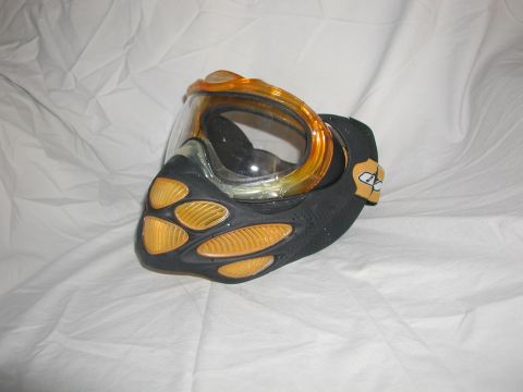 1985 Ford Bronco - Paintball mask with orange accents and a clear visor is displayed on a white cloth background.