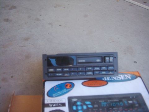 1978 Ford Bronco - A car stereo unit is placed on top of a box that advertises car audio equipment.