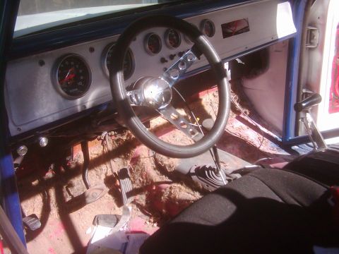 1978 Ford Bronco - The interior of a vehicle shows a custom steering wheel, multiple gauges, and a floor shifter, indicating a project in progress.
