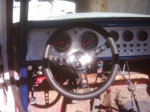 1978 Ford Bronco - Interior view of a vehicle's dashboard with custom gauges and a steering wheel.