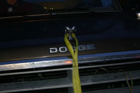 2003 Jeep TJ - Dodge truck grille with ram hood ornament and yellow tow strap attached.