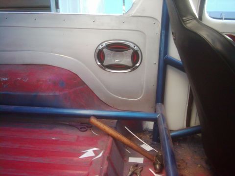 1978 Ford Bronco - The interior of a vehicle is shown, a roll cage and a speaker mounted on the panel.