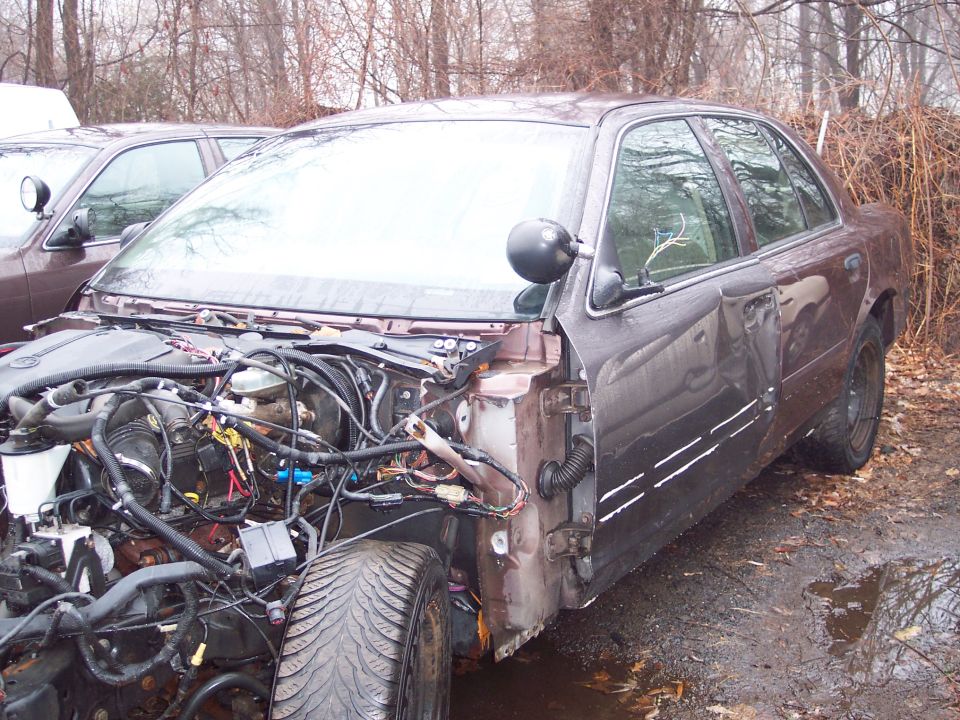1991 Ford Crown Victoria LTD with front end removed, showing engine and wiring. Dark brown exterior