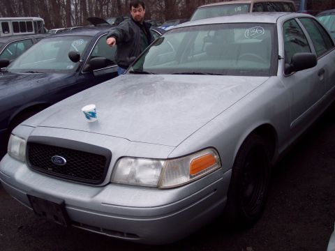 1991 Ford LTD Crown Victoria - Silver Ford Crown Victoria parked outdoors with a man pointing towards it.