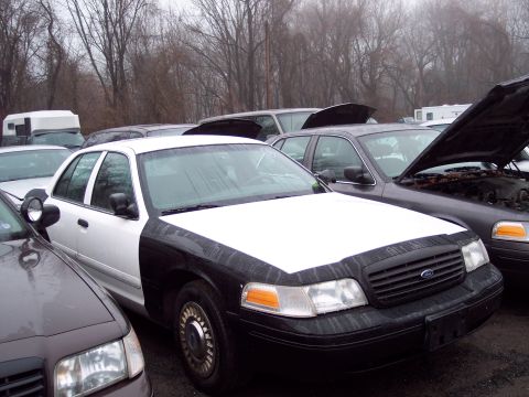 1991 Ford LTD Crown Victoria - Several Ford Crown Victorias are parked in an outdoor lot on a cloudy day.