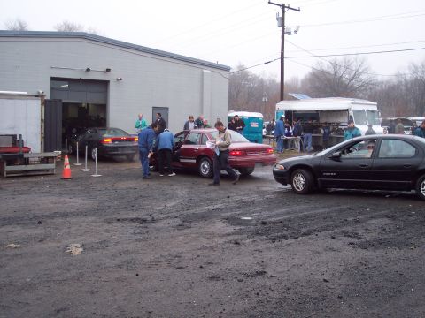 1991 Ford LTD Crown Victoria - A red 1991 Ford Crown Victoria LTD sedan is shown at an auction with people gathered around.