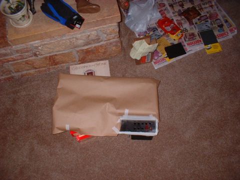 1986 Ford F-250 - A wrapped automotive part with exposed electrical connectors sits on the carpet.