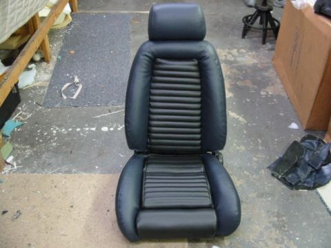 1987 Ford Thunderbird - A car seat is shown in a workshop setting with various materials and boxes in the background.