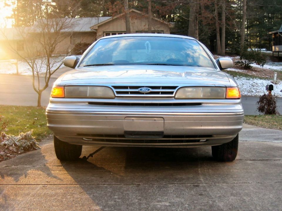 Front view of a silver Ford Crown Victoria parked on a driveway during the day