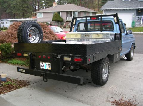 1968 Ford F-100 - This 1968 Ford F-100 pickup features a custom flatbed and a spare tire mounted on the side.