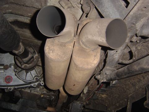 1993 Ford Bronco - Underside view of dual catalytic converters and exhaust pipes on a vehicle.