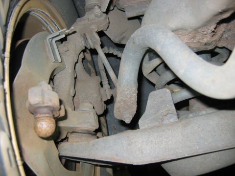 1985 Ford LTD Crown Victoria - This image shows the underside of a vehicle, focusing on the suspension system and brake components.