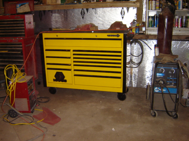 Yellow tool chest and Miller welding machine in a garage setting