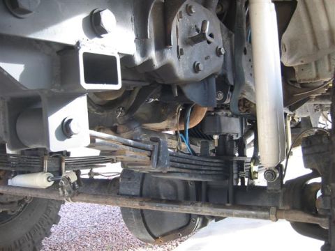 1994 Ford Bronco - Close-up view of the suspension system and drivetrain components of a heavy-duty vehicle.