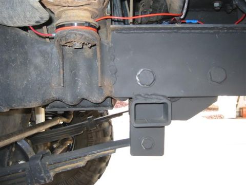 1994 Ford Bronco - Vehicle frame detail with suspension and trailer hitch receiver visible.