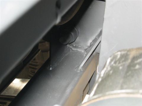 1994 Ford Bronco - Detail shot of the undercarriage, focusing on structural components and welding.
