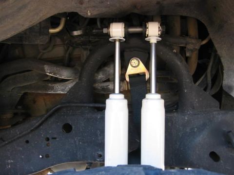 1994 Ford Bronco - Close-up view of white shock absorbers and suspension components, with visible Supermotors.net branding at the bottom right.
