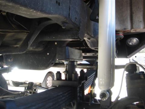 1994 Ford Bronco - Close-up of the suspension system, focusing on the shock absorber and leaf springs.