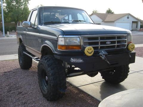 1994 Ford Bronco - This modified Ford pickup features an aftermarket bumper and oversized tires, giving it a appearance.