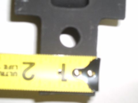 1996 Ford Bronco - A black metal shackle mount is shown with a yellow tape measure indicating a measurement of 2 inches.