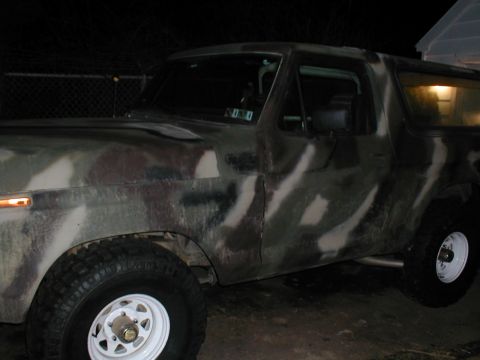1979 Ford Bronco - Camouflaged Ford Bronco, likely from the late 1970s, parked outdoors at night.