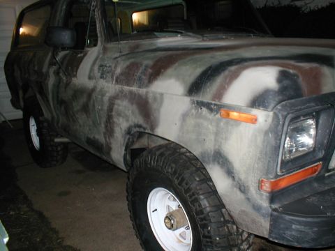 1979 Ford Bronco - This 1979 Ford Bronco features a distinctive camouflage paint job, visible from the front three-quarter angle.