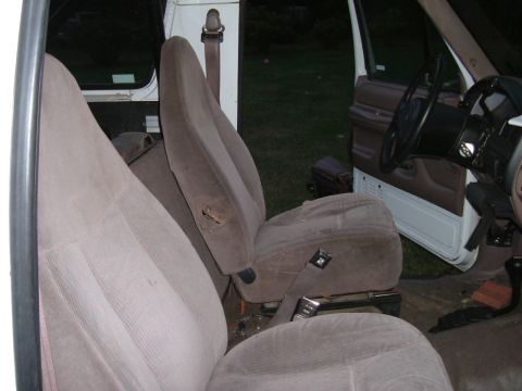 1993 Ford Bronco - Interior view of a vehicle's front seats and dashboard, with visible signs of age and use.