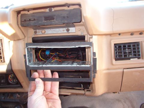1983 Ford Bronco - This is a DIN+1/2 bracket for an import truck (Mazda, I think) that I cut down & bent to fit. It has tabs on the R that slip around the pla…