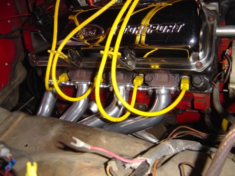 1978 Ford Bronco - Close-up of a Ford Motorsport engine valve cover and exhaust headers with yellow spark plug wires.